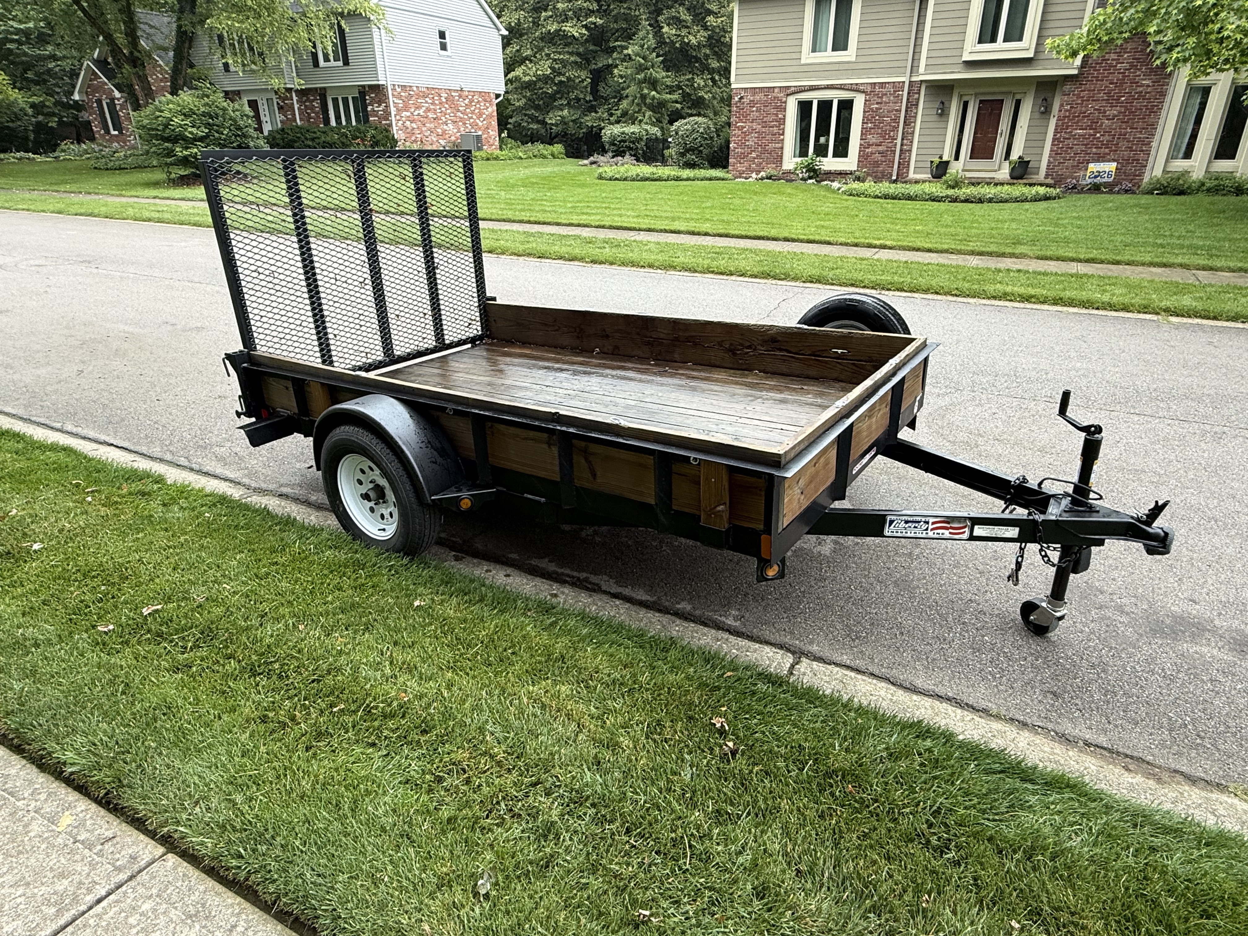 6x10 open utility trailer with drop down ramp parked on the street in Carmel Indiana